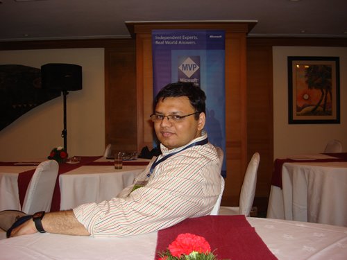 A man with a white lanyard and badge.